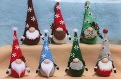 seven gnomes in different colors and sizes with snowflakes on them