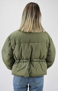 Warm and Fashionable. This cropped puffer jacket adds just the right style to any outfit while keeping you warm. The jacket has a front zipper and pockets to maximize fashion and ease with a back adjustment to cinch the waist for the most flattering fit. Wear this now for those chilly days or on gameday to add just the right color to your outfit. Pairs nicely with Color Fleece Crop. Color-Olive Green (also available in Stone, Blue, Teal, Cheddar Gold, Caramel, Cream, Black, Pale Lavander, Charcoal Blue, Pale Pink, Sky Blue, Hot Pink, Milk Chocolate, Orange, Green, and Lime Green) 80% Polyester 20% Nylon Cropped Winter Outerwear With Zipper, Cropped Outerwear With Zipper Closure For Winter, Nylon Utility Puffer Jacket For Fall, Cropped Puffer Jacket For Spring, Spring Cropped Puffer Jacket, Spring Streetwear Cropped Puffer Jacket, Casual Cropped Nylon Outerwear, Spring Cropped Puffer Jacket For Streetwear, Winter Cropped Utility Outerwear