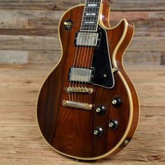 an electric guitar sitting on top of a wooden table