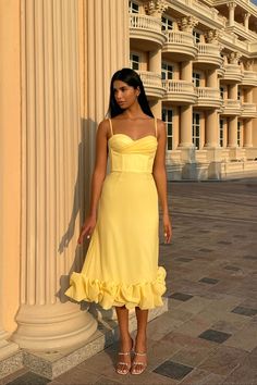 Flounce Bustier Midi Dress in Yellow Color. The corset with bones and cups flatters the body shape while the flounce in the bottom creates a dreamy and romantic feel. The dress fastens with a hidden zipper. Lined. Sweetheart Neckline Midi Dress With Ruffle Hem For Party, Party Midi Dress With Sweetheart Neckline And Ruffle Hem, Elegant Corset Dress With Ruffled Straps For Party, Formal Corset Dress With Sweetheart Neckline And Ruffles, Cocktail Corset Dress With Spaghetti Straps And Ruffles, Fitted Midi Corset Dress With Pleated Bodice, Elegant Corset With Sweetheart Neckline And Pleated Bodice, Elegant Fitted Corset Dress With Ruffles, Elegant Spaghetti Strap Evening Dress With Ruffles