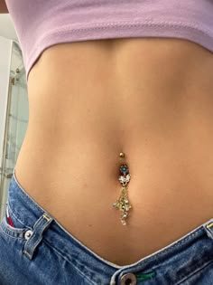 a woman's stomach with a gold chain attached to it