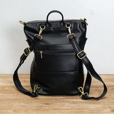 Carry everything you need with this timeless leather backpack. The bag is made with 100% vegan leather, making it durable and long-lasting. The convertible strap also allows you to easily switch between using the backpack or shoulder bag mode. Colors: Black & Sand Size: L 12.60" x H 14.20" x D 5.50" Material: Made with 100% Vegan Leather Origin: Imported The actual color of this product may vary slightly under different lighting conditions. Everyday Satchel Backpack With Zipper Closure, Everyday Satchel Backpack With Zipper, Functional Leather Backpack With Adjustable Strap For Everyday, Versatile Everyday Leather Backpack With Zipper Closure, Everyday Versatile Leather Backpack With Zipper Closure, Everyday Versatile Leather Backpack With Zipper, Modern Faux Leather Backpack For Everyday, Daily Use Standard Backpack With Adjustable Strap, Modern Faux Leather Backpack For On-the-go