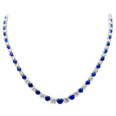 Luxurious and elegantly made riviere tennis necklace showcasing brilliant round blue sapphires and diamonds that elegantly alternate with each other and get larger to the center of the necklace. Set in a classic four prong basket setting. Blue sapphires weigh 17.66 carats total and Diamonds weigh 13.15 carats total, G-H color and SI1-SI2 in clarity. Finely made in 18k white gold, 17 inches, adjustable upon request. Roman Malakov is a custom house, specializing in creating anything you can imagine. If you would like to receive a special quote on a custom piece please message or call us. Round Lab-created Sapphire Necklace Fine Jewelry, Anniversary Round Gemstone Tennis Necklace, Anniversary Gemstone Tennis Necklace, Classic Sapphire Necklace With Prong Setting, Classic Sapphire Necklaces With Prong Setting, Elegant Round Gemstone Tennis Necklace, Round Diamond Cut Necklace With Lab-created Sapphire, Round Diamond Cut Lab-created Sapphire Necklace, Elegant Gemstone Tennis Necklace