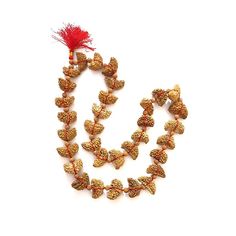 This 1 Mukhi Rudraksha Half Moon Shaped Mala is consists of 33 Rudraksha Beads of 1 Mukhi that are string in a red colored thread. 1 Mukhi Rudraksha Mala brings overall prosperity, good luck, and happiness to the Wearer. Color: Beige Brown Mix Total Beads: 32+1 Size of Beads: 27mm to 32mm Shape of Bead: Half-moon Shape Length of Mala: 18 Inches approx. *Please note that as Rudraksha is Natural Gift of nature, the pattern and color on beads might vary depending upon lot to lot. (Images shown in l Traditional Beaded Necklaces For Rituals And Festivals, Festive Temple Necklace With Round Beads For Rituals, Traditional Tilla Beaded Necklaces For Puja, Traditional Tilla Beaded Necklaces For Rituals, Temple Necklace With Latkans And Round Beads For Festivals, Temple Jewelry Beaded Necklaces For Puja Festivals, Festive Temple Jewelry Beaded Necklaces With Latkans, Traditional Beaded Necklaces For Diwali Rituals, Festive Temple Jewelry Beaded Necklace With Latkans