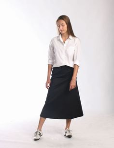 "Be right on clean minimal look with Aline midi skirt in timeless simplicity Black cotton skirt sits a little high on waist making your silhouette long and lean Midi length is super chic for this season Pair with simple top and heels or knee high boots to keep style minimal and polished Or wear as a chic casual skirt paired with snickers or athletic shoes -Tailored fit -Waist sits around naval -Side hidden zipper -Made of soft feel medium weighted cotton fabric with hint of stretch -Finishing is Fitted Maxi Skirt For Office, Office Long Stretch Pencil Skirt, Relaxed Midi Pencil Skirt With Lining, Long Pencil Skirt For Workwear, Office Pencil Skirt In Cotton, Long Lined Pencil Skirt For Workwear, Fitted Lined Maxi Skirt For Office, Stretch Full Maxi Skirt For Workwear, Cotton Mini Pencil Skirt For Work