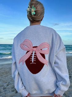 Discover the ultimate game day sweatshirt - the Game Day Coquette Bow Football Embroider Sweatshirt. Embroidered Long Sleeve Tops For College, Sporty Crew Neck Sweatshirt With Machine Embroidery, Pink Long Sleeve Sweatshirt With Machine Embroidery, Embroidered Long Sleeve College Sweater, Pink Long Sleeve Sweatshirt With Embroidery, Embroidered Long Sleeve Sweater For College, Pink Embroidered College Sweatshirt, Sunkissed Coconut, Casual Autumn Outfits Women