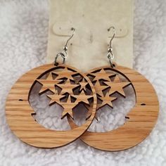 two wooden earrings with stars on them