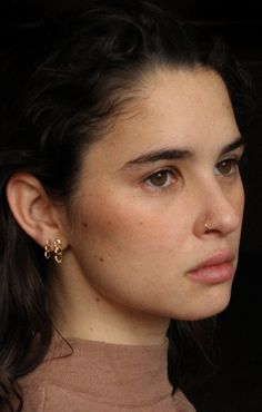 a close up of a person wearing earrings