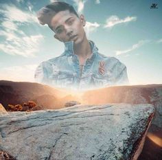 a man standing on top of a large rock