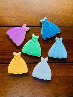 some cookies that have been decorated to look like princess dresses