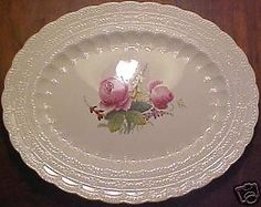 a white plate with pink roses on it