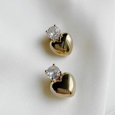 Elevate any outfit with The Scarlette Studs, featuring a puffed heart design adorned with a sparkling touch of cubic zirconia. Perfect for adding a touch of elegance and charm to any look. 18k Gold-Plated Brass Cubic Zirconia Post back closure Drop 15mm Gold Luxury Heart Earrings For Formal Occasions, Clean Metal, How To Clean Metal, Puffed Heart, Cuff Rings, Earring Sale, Huggie Hoop Earrings, Lariat Necklace, Mild Soap