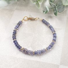 This juicy gemstone beaded bracelet is full of color!  The bracelet band is made of the most beautiful purpley- blue 4mm iolite rondelle beads.  Every fifth rondelle bead is accented with a 14k gold filled heishi bead.  A simple 14k gold filled minimalist lobster claw finishes off this bracelet.  This sweet, delicate bracelet is bursting with color and would look amazing alone on your wrist or paired with friends for your own unique stack.  It can also make a very thoughtful gift for friends and Handmade 14k Gold-filled Bohemian Bracelet, Handmade Bohemian 14k Gold-filled Bracelet, Handmade 14k Gold Filled Bohemian Bracelet, Bohemian Blue 14k Gold-filled Jewelry, Blue Bohemian 14k Gold Filled Jewelry, Bohemian Blue 14k Gold Filled Jewelry, Everyday 14k Gold-filled Bracelets With Gemstone Beads, Everyday 14k Gold Filled Gemstone Beads Bracelets, Everyday 14k Gold Filled Bracelets With Gemstone Beads