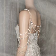 This shoulder chain is crafted with high-quality glass imitation pearl and rhinestones.  Elegant and sparkling.   The pearl size is 6mm, and the rhinestone accessories are about 15*20mm.  The pearl size can be larger or smaller.   If you need to customize, you can contact me.  Thank you！ Delicate Silver Body Chain For Party, White Pearl Body Jewelry With Pearl Chain, Pearl Beaded Body Chain For Wedding, Elegant White Body Jewelry For Evening, White Beaded Pearl Body Jewelry, Elegant Beaded Pearl Body Jewelry, Elegant White Body Jewelry With Pearl Chain, Elegant White Pearl Chain Body Jewelry, Glamorous Crystal Body Chain For Wedding