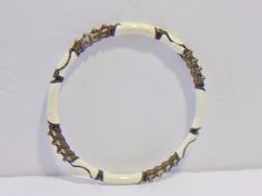 White and gold bangle bracelet. White enamel with gold metal accents. Add it to your jewelry wardrobe. Pre owned. In good condition. All sales are final and as is. Thank you for looking. You may also love this: https://www.etsy.com/listing/448818876/vintage-black-white-graduated-bead?ga_search_query=white%2Bjewelry&ref=shop_items_search_53 White Adjustable Bangle Jewelry, Bohemian White Bangle Jewelry, White Handmade Bohemian Bangle, Handmade White Bangle Stretch Bracelet, Handmade White Stretch Bangle Bracelet, White Adjustable Bangle With Unique Style, Unique Adjustable White Bangle, Handmade White Bangle Bracelet, Handmade White Beaded Metal Bracelets