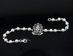 This amazing silver Rakhi crafted from 925 silver with immense precision. It exudes excellent craftsmanship and will surely look wonderful on your brother's wrist. handmade custom design God divine Bracelet Or Rakhi bracelet with silver, rudraksha and silver beaded chain, this is special design beaded bracelet we can use either Rakhi bracelet or daily use bracelet for unisex. Best Rakshabandhan Festival best wishes sibling gift for your brother and sister's , Metal-925 sterling silver. Item type Silver Symbolic Rosary Bracelet As Gift, Symbolic Silver Rosary Bracelet Gift, Symbolic Silver Rosary Bracelet, Symbolic Silver Rosary Bracelet For Gifts, Silver Beaded Bracelets With Round Beads For Festivals, Sterling Silver Bracelet For Festivals And Gifts, Sterling Silver Bracelet As Festival Gift, Sterling Silver Bracelet For Festivals Gift, Sterling Silver Bracelet For Festivals