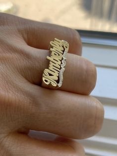 Medium Size Personalized Name Ring In Real 10K & 14K Gold *FLAT FACE * MADE IN USA (HAND MADE ITEM) Make the names of your family, friends and love ones into rings for their gift. It's great as an everyday necklace and makes an awesome gift! This Item is 100% customization especially for you. Item Description *Material: Real Gold *Type: *FLAT FACE* ( Like photo) with Heart Tail with Bit Work *Ring size: ring sizes between 1-11 (including half sizes) *Size of Ring : 20mm*8mm *Script Design *O Script Design, Flat Face, Like Photo, Name Ring, Name Rings, Gold Flats, Birthday List, Everyday Necklace, Name Jewelry