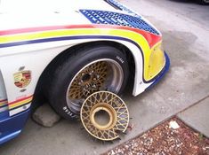 a white and blue car parked next to a curb