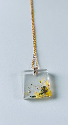 Elevate your style with our Yellow Meadow Flower Necklace. Handcrafted with intricate gold and clear flower designs, this necklace is perfect for adding a touch of nature to your look. Floral Pendant Necklace, Meadow Flowers, Floral Pendant, Real Women, Flower Necklace, Real Flowers, Gold Leaf, Flower Designs, Favorite Jewelry