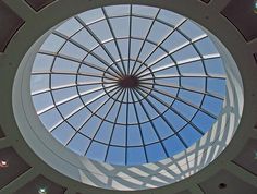 the inside of a building with a skylight in it's center and lots of windows