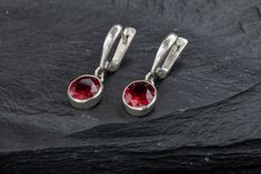 Oval Ruby Earrings set with a Created Ruby in a flawless diamond cut & clarity, deep red color, at 10x8mm (6 Cts a pair).Solid 925 Sterling Silver ☞ made to last. Click here for ☞ Matching Ring Matching Pendant ☞ please ask me Details:• Created Ruby in a deep red color• Ruby: 10x8mm each, 6 Cts a pair, diamond cut• Lever Back Closure - "English Lock"• Dimensions: Length 29mm, Width 9mm• Solid 925 Sterling SilverSKU 1118 Polished Sterling Silver Round Cut Earrings, Red Polished Earrings For Gift, Elegant Red Sterling Silver Hoop Earrings, Red Round Earrings With Polished Finish, Teardrop Earrings With Bail As Gift, Sterling Silver Hoop Earrings With Bail As Gift, Red Polished Fine Jewelry Earrings, Sterling Silver Diamond Earrings With Bail As A Gift, Red Polished Finish Fine Jewelry Earrings