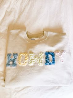 a t - shirt with the word hod on it is laying on a bed