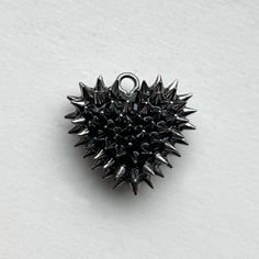 Make a statement with the Micro Spiked Heart Necklace by Bunny Paige. Handcrafted in Cleveland, the pendant features 100 micro spikes each applied by hand to a resin base. This pendant is perfect for everyday wear, adding a touch of edge to any outfit. DETAILS Heart Charm: .75” wide Chain: 18” chain SIZE CHART Black Spiked Jewelry Gift, Black Spiked Jewelry For Gifts, Black Spiked Jewelry As Gift, Chain Size Chart, Metal Jewelry Handmade, Dark Jewelry, Gold Heart Necklace, Funky Jewelry, Jewelry Inspo