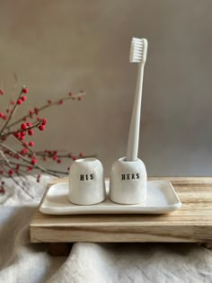 two ceramic toothbrush holders on a tray