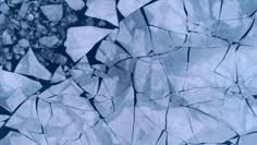 an image of ice that is melting on the ground in blue and white colors,