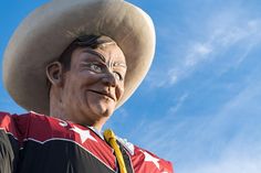 a statue of a man wearing a cowboy hat