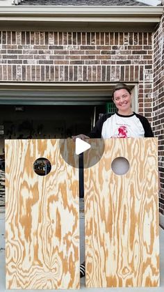 a woman standing in front of a door made out of plywood