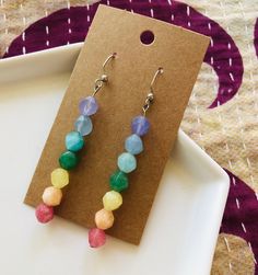 Faceted Multicolored Quartz Chakra Earrings These dangle chakra earrings feature 7 dyed quartz stones on a nickel-free fish hook ear wire. Each gemstone's color corresponds with one of the 7 main energy centers of the body's chakra system and encourages harmony and balance. These earrings add personal flair to your favorite boho and hippie fashions, and they also make a great gift!  This listing is for one pair of earrings. The drop length is approximately 6 inches.  Please Note: Due to the colo Rainbow Crystal Drop Earrings For Gift, Multicolor Nickel-free Crystal Earrings For Gift, Multicolor Natural Stones Beaded Drop Earrings, Multicolor Beaded Drop Earrings With Natural Stones, Adjustable Multicolor Crystal Earrings For Gift, Single Rainbow Earring For Gift, Rainbow Single Earring As Gift, Adjustable Multicolor Earrings With Natural Stones, Multicolor Nickel Free Dangle Crystal Earrings