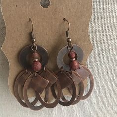 Hand-Crafted Bronze Turquoise Earrings And Red Creek Jasper Rust Bohemian Earrings For Pierced Ears, Adjustable Rustic Metal Earrings, Adjustable Rust Earrings With Ear Wire, Artisan Metal Earrings In Rust Color, Rustic Brown Drop Earrings, Red Copper Dangle Earrings, Artisan Metal Rust Earrings, Bohemian Red Soldered Earrings, Red Bohemian Soldered Earrings