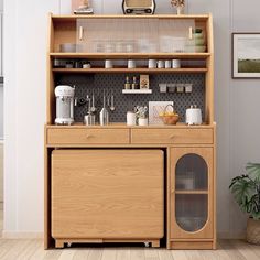 a wooden cabinet with glass doors and shelves on the top, next to a potted plant