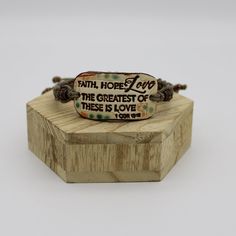 Faith, Hope, Love, The Greatest of these is Love inspirational bracelets. They have hand painted ceramic connectors and tan handmade adjustable macramé hemp bands. The perfect gift for your wife, mom, daughter, granddaughter, sister or best friend. Great Valentine Day Gift, Mother's Day Gift, Graduation Gift, Birthday Gift or Christmas Gift. Gorgeous beige bracelet connector has Christian Quote on a macramé tan bracelet band that adjusts to almost any wrist size. Each finely crafted piece of Christian jewelry features an excerpt from the Bible and these motivational words of Scripture provide comfort and encouragement for all walks of life, serving as a constant reminder of God's spiritual presence. These beautiful bracelets are handmade and painted ceramic with handmade macrame tan hemp c Inspirational Handmade Adjustable Friendship Bracelets, Handmade Inspirational Adjustable Friendship Bracelets, Adjustable Hand Painted Bracelets For Gift, Beige Bracelet, Love Christian, Christian Bracelets, Encouragement Gift, Message Bracelet, Christian Quote