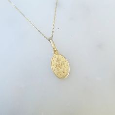 This stunning 14k Gold Miraculous Mary Medal is 18 inches in length, with a 16 inch jump ring for an adjustable fit. Made entirely of 14k gold, it is a small but magnificent piece. With the Medal of Our Lady of Graces, also known as the Miraculous Medal, one can carry a symbol of protection and divine grace. This Catholic jewelry serves as a reminder of Mary's eternal love and intercession for God's blessings. Wear it with love and trust, not as a mere lucky charm. Let it visibly show your devot 14k White Gold Charm Necklace With Adjustable Chain, 14k Yellow Gold Tarnish Resistant Charm Necklace, Dainty Recycled Gold Necklace With Polished Finish, Dainty Necklace In Polished Recycled Gold, Fine Jewelry 14k Gold Oval Pendant Necklace, Dainty Polished Recycled Gold Necklace, 14k Gold Oval Pendant Necklace, 14k Yellow Gold Medallion Charm Necklace, Gold 14k Polished Finish Charm Necklace