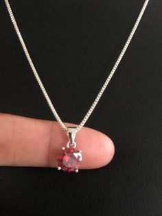 "Sterling Silver Garnet Necklace, Garnet Cubic Zirconia Pendant Necklace NECKLACE FEATURES: Metal: All components are made from solid .925 Sterling Silver Model is wearing 16\" in length solid .925 Sterling Silver Chain Length available: 16\", 18\" or 20\" Stone: Garnet CZ THE Garnet CZ pendant measures 8mm in height Your Garnet Necklace will arrive in a gift box, beautifully wrapped and ready for gifting Please send me a convo if you have any questions before placing your order. Please also vie Round Cubic Zirconia Necklaces For Birthday, Red Sterling Silver Necklaces For Birthday, Round Cubic Zirconia Birthday Necklace, Classic Red Birthstone Necklace As Gift, Classic Red Birthstone Necklace For Gift, Elegant Red Necklace For Birthday Gift, Red Round Necklace For Birthday Gift, Silver Model, Garnet Necklace