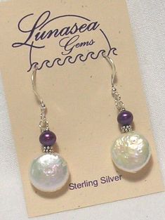 BEADED DANGLE EARRINGS OF FRESH WATER PEARLS by LUNASEA TREASURES.  DESIGN INCLUDES A 12mm COIN SHAPED WHITE PEARL TOPPED WITH A 5mm POTATO SHAPED PURPLE PEARL.  THEY ARE ACCENTED WITH STERLING SILVER RONDELLES.  EARRINGS DANGLE 7/8" FROM FRENCH EAR WIRES.   ALL FINDINGS ARE STERLING SILVER.  SAFETY BACKS ARE INCLUDED.  ANOTHER PRETTY DESIGN FROM NEW ENGLAND. Froo www.froo.com | Froo Cross Sell, Free Cross Sell, Cross promote, eBay Marketing, eBay listing Apps, eBay Apps, eBay Application Flat Pearl Earrings, Simple Bead Earrings, Pearl Earrings Designs, Coin Pearl Earrings, Pearl Earrings Handmade, Silver Bead Earrings, Beaded Jewelry Necklaces, Pearl Jewelry Design, Freshwater Pearl Jewelry