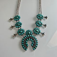 This statement piece is sure to make a statement at any event: the It Takes Two Squash Blossom Necklace. Features include a choice of turquoise or turquoise and white Squash Blossom Necklace, It Takes Two, Squash Blossom, Double Chain, It Takes, Statement Pieces, Silver Chain, Blossom, Take That