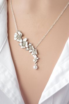 "Silver Necklace Orchid Necklace Flower lariat Necklace Flower Wedding Bridal Bridesmaid gifts Bridesmaid Jewelry Valentin gift The delicate, exotic and graceful orchid represents love, luxury, beauty and strength Feminine, elegant combination of silver and white swrovski Pearls. * Tarnish Resistant Silver Plated over Brass * 16mm(w) x 34mm(h) Necklace is 16 1/2 inches with Luster silver plated you may choose any length up to 20\". (NO EXTRA COST) Please leave a note at checkout to specify an al Bridesmaid Gift Necklace With Flower Charm, Delicate Silver Jewelry With Flower Decoration, Flower Charm Jewelry For Wedding And Mother's Day, Mother's Day Wedding Jewelry With Flower Charm, Delicate Flower Necklace For Wedding, Adjustable Flower Charm Jewelry For Wedding, Elegant Flower Pendant Necklace For Bridesmaid Gift, Delicate Flower Jewelry For Wedding Gift, Dainty Flower Pendant Jewelry For Wedding