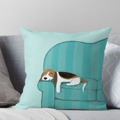 a dog laying on top of a blue couch with its head resting on the pillow