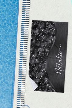 an image of a towel on the side of a swimming pool with water in it