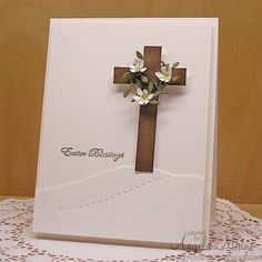 a card with a cross and flowers on it