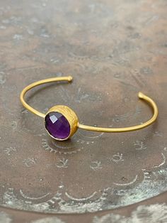 21 ct gold plated brass. Amethyst.  semi-precious stone Free size  Designed by our Turkish designer. Handcrafted with great care. Due to this is semi-precious stone, they might have cracks. Size and Color slightly differ from what you see on your screen. We will send within 3 working days! Spiritual Round Cuff Bracelet With Natural Stones, Spiritual Gemstone Cuff Bracelet Gift, Handmade Amethyst Cuff Bangle Bracelet, Handmade Amethyst Bangle, Bohemian Gemstone Bangle As Gift, Amethyst Bangle For Gift, Spiritual Amethyst Cuff Bracelet In Purple, Spiritual Purple Amethyst Cuff Bracelet, Adjustable Gemstone Cuff Bangle