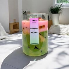 a candle that is sitting on top of a table with some fruit inside of it