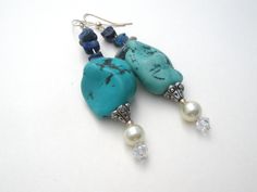 Hand Made Statement Jewelry - This is a substantial pair of silver dangle drop pierced earrings with large turquoise nuggets, blue sodalite, faux pearls and aurora borealis crystal beads. They 3.25" long and are slightly over .75" wide and weigh 25.6 grams. Blue Beaded Earrings With Natural Stones, Adjustable Blue Pearl Drop Jewelry, Turquoise Dangle Earrings With Polished Beads, Blue Bohemian Pearl Drop Earrings, Blue Large Beads Dangle Earrings, Blue Pearl Drop Bohemian Earrings, Turquoise Large Beads Drop Earrings, Elegant Turquoise Pearl Drop Earrings, Bohemian Polished Beads Turquoise Earrings