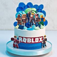 a birthday cake decorated with cartoon characters and the words robblox on it's side