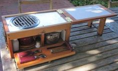 an outdoor bbq grill on top of a wooden table