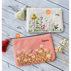 two personalized zipper pouches with flowers and tassels on the side, one for sale