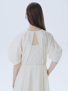 This is a modern and unique dress by ahwe that is made out of high quality and sturdy fabric. With minimal design detail and trendy mood, you can style it for your casual and refined daily outfit.- Voluminous lantern sleeves- U neckline with shirring- Dart detail on the sleeves- Diagonal pleat and cutout detail on the back Spring Cotton Puff Sleeve Dress With Lantern Sleeves, Chic Cotton Dresses With Bishop Sleeves, Cotton Dresses With Gathered Balloon Sleeves, Cotton Dresses With Balloon Sleeves, Cotton Mini Dress With Balloon Sleeves, Billowy Cotton Dress With Balloon Sleeves, Cotton Puff Sleeve Dress With Bishop Sleeves, Chic Puff Sleeve Dress With Pleated Voluminous Sleeves, Cotton Puff Sleeve Dress For Brunch